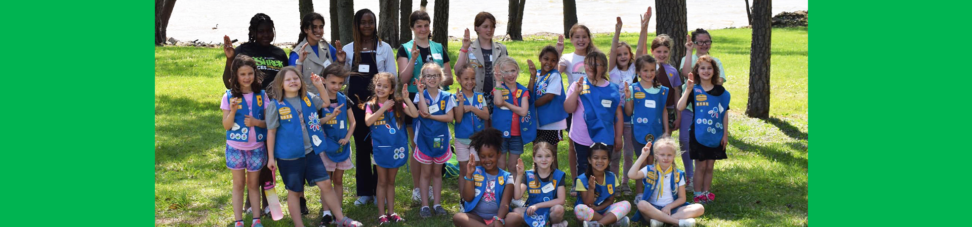  girl scouts posing together outside for a group photo 