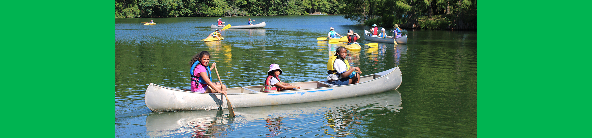  girl scout campers smiling and posing with their camp unit for a group photo 