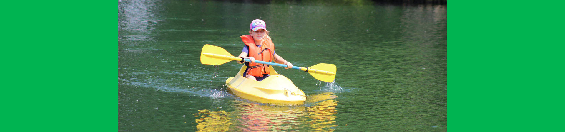  girl scout kayaking on a lake 